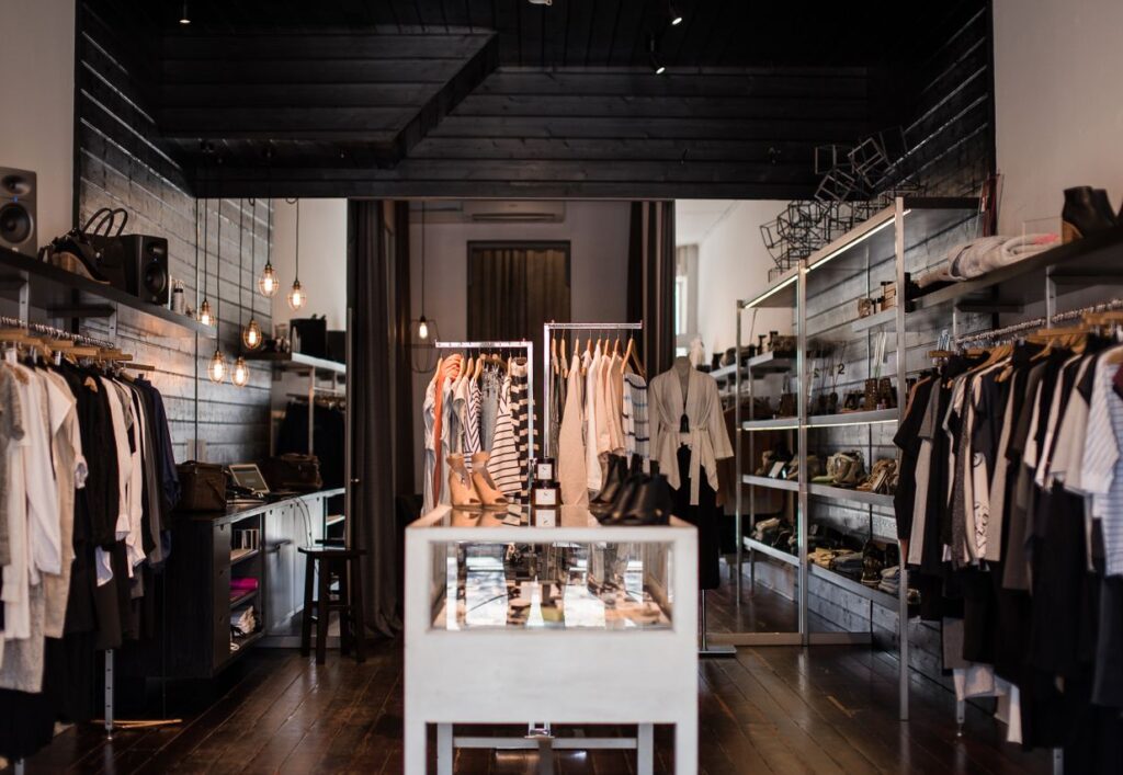 Explore the chic interior of a modern fashion retail store with clothing displays.